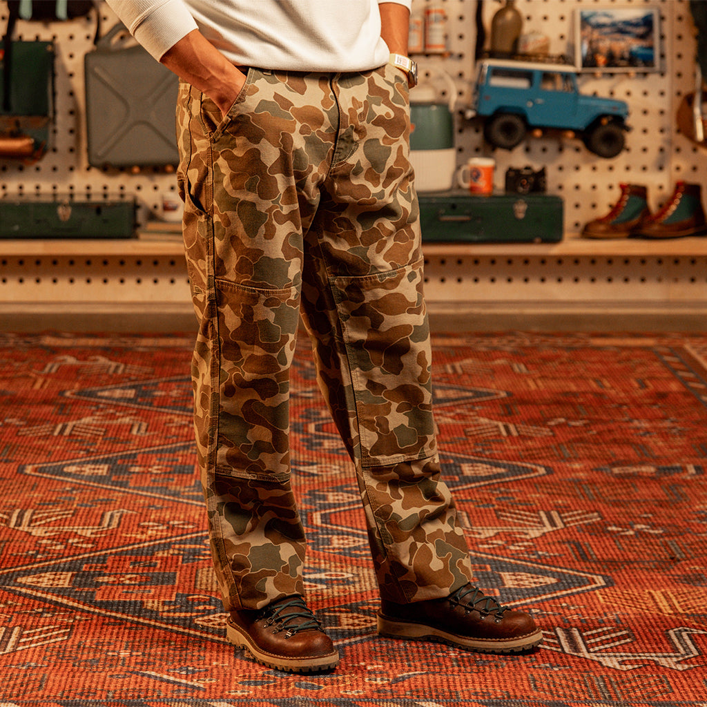 Image of a man wearing "Duck Camo" Utility Pants