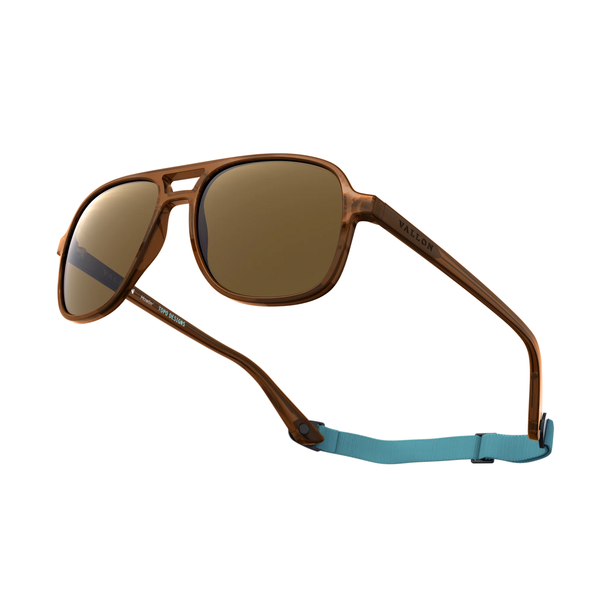 General alternate angled view of VALLON X Topo Designs sunglasses in "Brown / Brown" with sunglass arms open with strap attached.