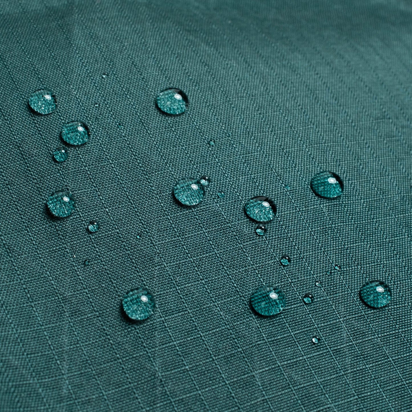 General shot of Topo Designs Global Pro Tech Case water droplets on waterproof material