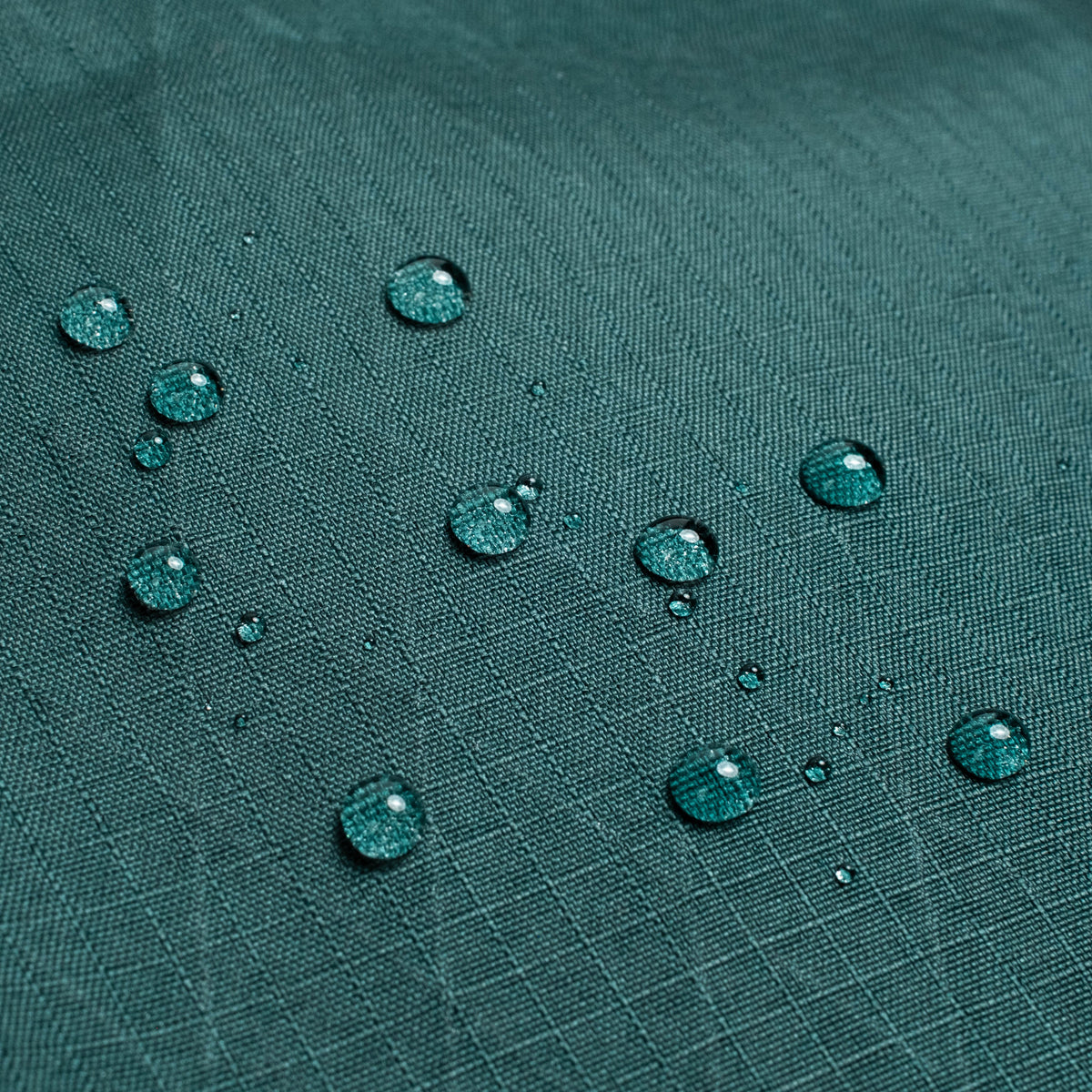 General back shot of Topo Designs Global Pro Travel Roller Bag showing water droplets on waterpoof material